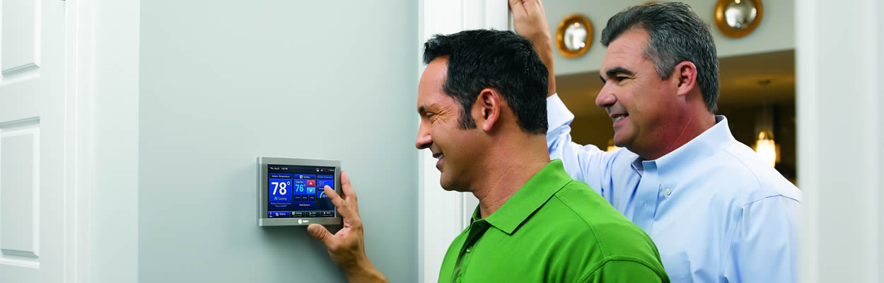 trane tech showing customer how to use smart thermostat