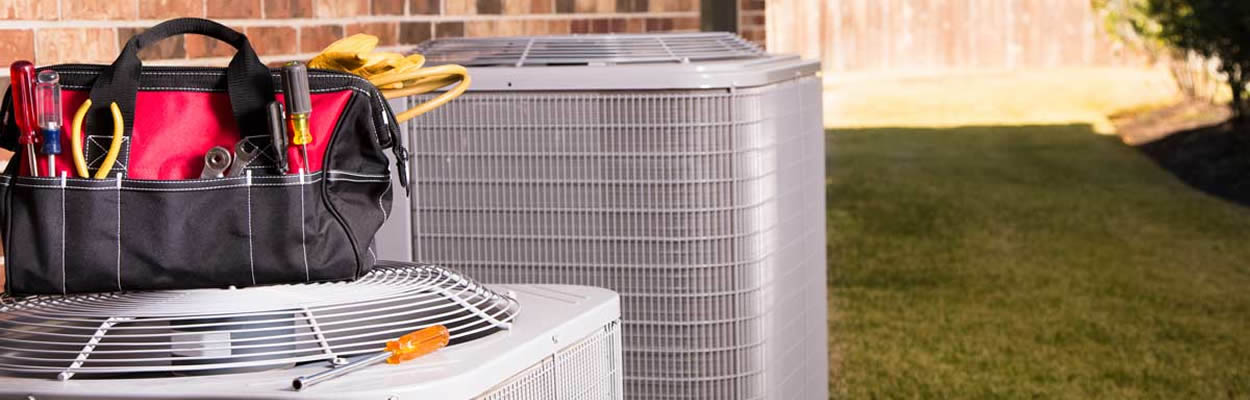 two hvac units with tools on top