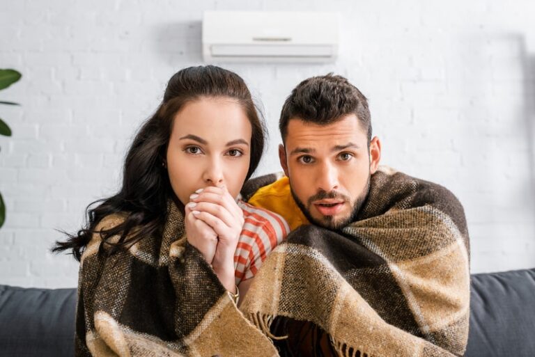 Couple Wrapped In Blanket With Broken Ductless Heat