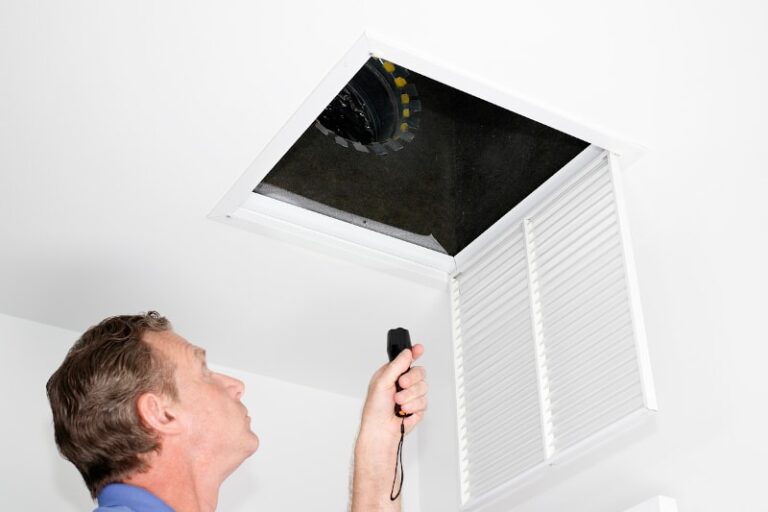 Professional With Flashlight Looking At Ducts